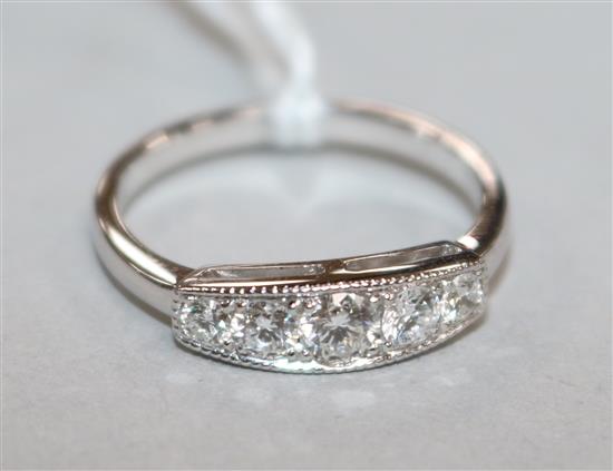 A five-stone graduated diamond half-hoop ring, 18ct white gold setting, size L.